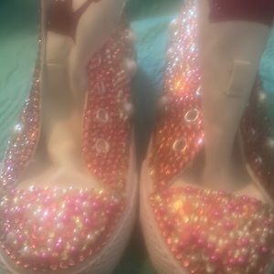 Blinged out tennis shoes with pink and white pearls.